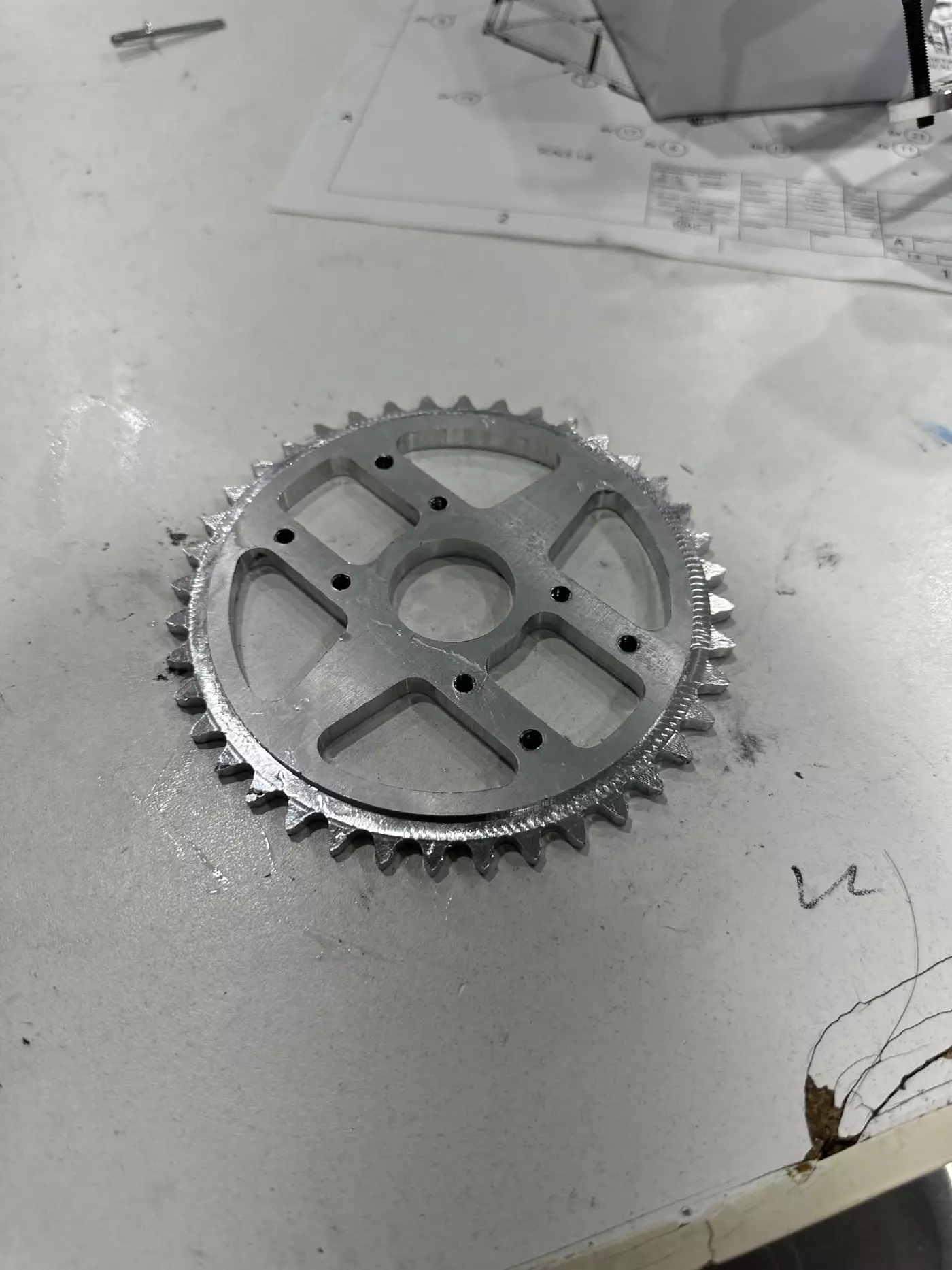 A freshly machined aluminum sprocket on a workbench